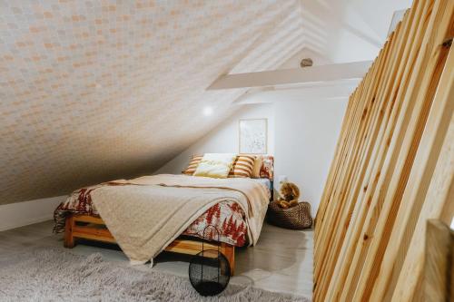 a bedroom with a bed in a attic at Apartament z antresolą in Okszów