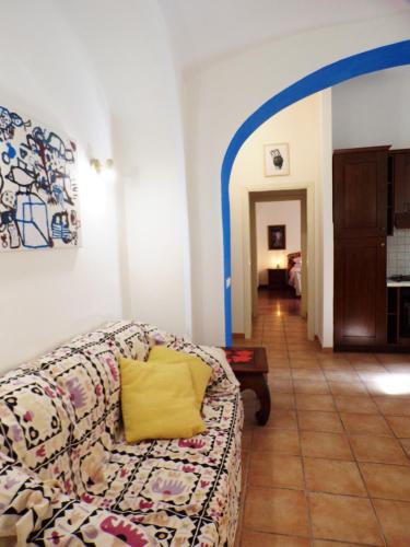 a living room with a couch with a yellow pillow at Lovely Apartment in Testaccio, Rome in Rome