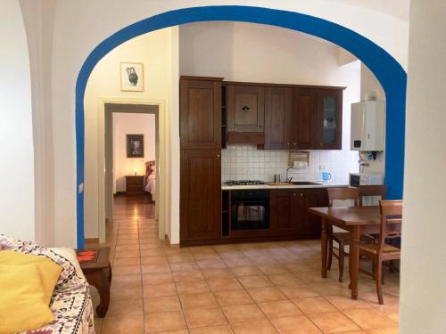 a kitchen with a table and a blue archway at Lovely Apartment in Testaccio, Rome in Rome