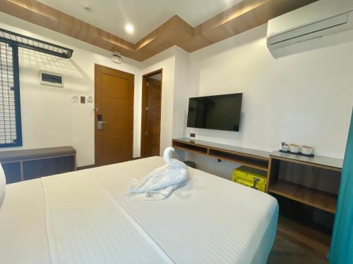 a room with a bed with a bird sitting on it at Lighthouse Point Hotel in Dumaguete