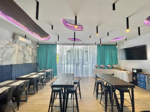 a dining room with wooden tables and chairs at Lighthouse Point Hotel in Dumaguete