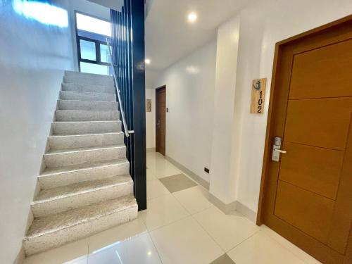 a staircase in a house with a door at Lighthouse Point Hotel in Dumaguete