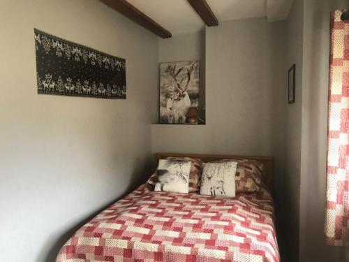 a bedroom with a bed with a deer on it at La Petite Finlande in Orbey