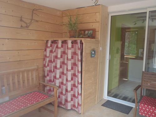 a room with two chairs and a sliding glass door at La Petite Finlande in Orbey