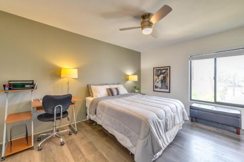 a bedroom with a bed and a desk and a window at Pool Access Pet-Friendly Palm Springs Condo in Palm Springs