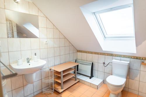 a bathroom with a sink toilet and a window at Summerhouse penzion Bavory in Bavory