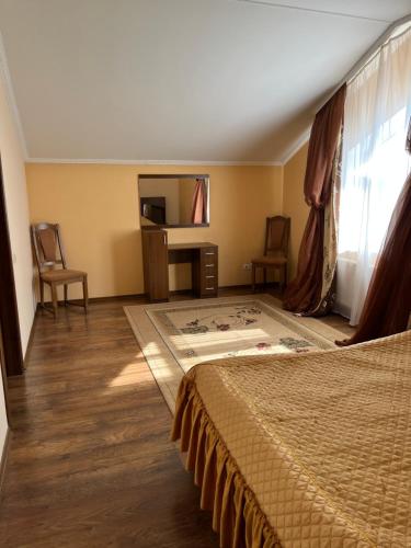 a hotel room with a bed and a window at Готель МАГНАТ in Sutysky