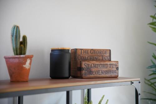 a shelf with two books and a cactus at IndieHaus in Lincolnshire
