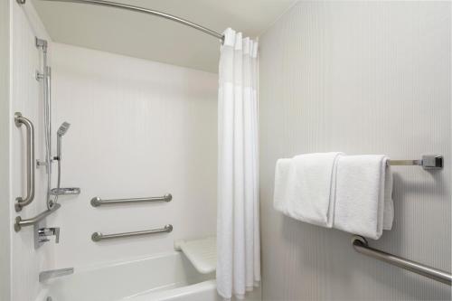 a bathroom with a shower and a shower curtain at Courtyard by Marriott- Austin Round Rock in Round Rock