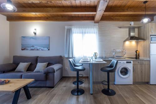 a kitchen and living room with a couch and a table at Villas Spa El Mirador de Isla in Isla