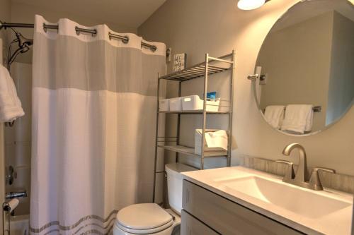 Un baño con lavabo, inodoro y espejo. en 30399 Pavillion Drive, en Ocean View