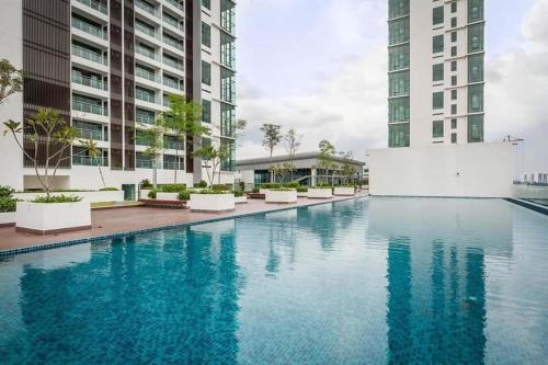 a large swimming pool with two tall buildings at MHA 15 SUlTE EVO SOHO BANDAR BARU BANGI FREE NETFLIX AND WIFI in Bandar Baru Bangi