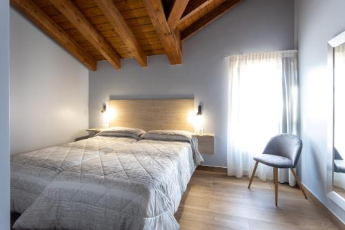 a bedroom with a large bed and a chair at Villas Spa El Mirador de Isla in Isla