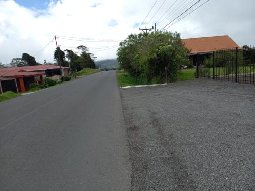 an empty road next to a house with a fence at Deluxe boutique lodge in Vara Blanca