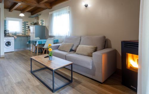 a living room with a couch and a table with a fireplace at Villas Spa El Mirador de Isla in Isla