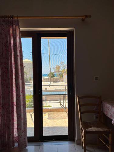 a sliding glass door with a view of a patio at Dimitra Rooms in Lefkada Town