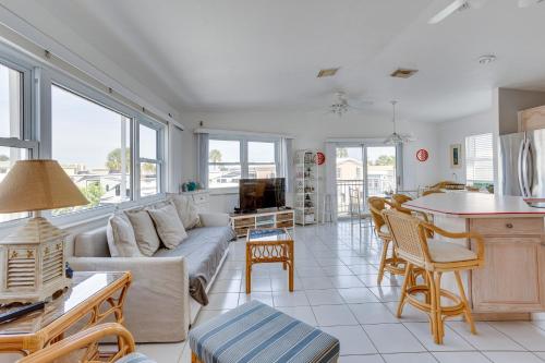 a living room with a couch and a table at Nettles Island, Jensen Beach Home with Patio and Grill in Jensen Beach