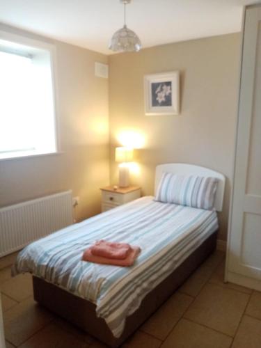 a bedroom with a bed with a towel on it at 33A Steepleview in Trim