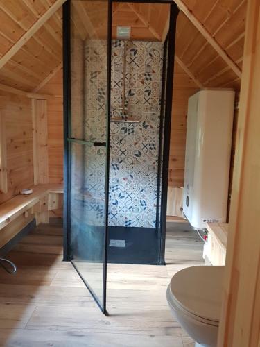 a shower in a room with a glass door at Kota SHANTYHOME in Saint-Martin-dʼArc