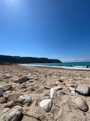 a group of rocks on a sandy beach at Dimitra Rooms in Lefkada Town