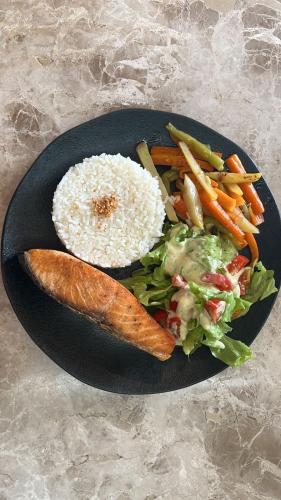 a plate of food with rice and vegetables on a table at Isla Beach Hotel in Pecém