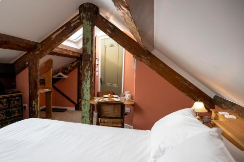 a bedroom with a bed and a table in a room at The Fanny Talbot in Barmouth