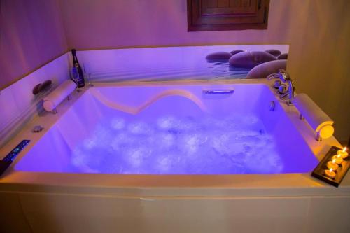 a jacuzzi tub in a room with purple lighting at Villas Verdemar in Isla
