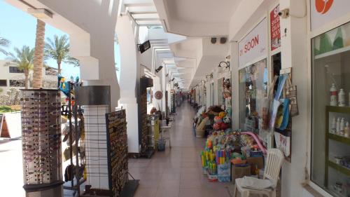 an aisle of a store with people shopping in it at Sharm Hills Resort in Sharm El Sheikh