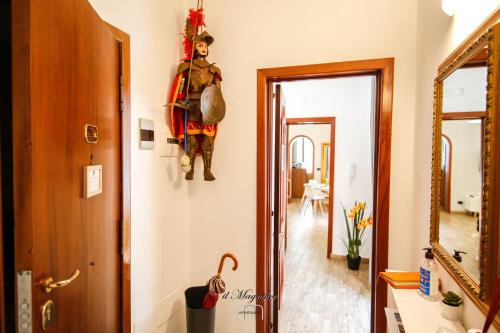 a hallway with a room with a door and a mirror at Il Magnifico Apartment in Catania