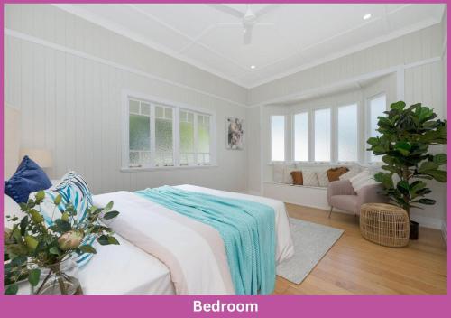 a white bedroom with a bed and a window at Harold Street 139 in Townsville