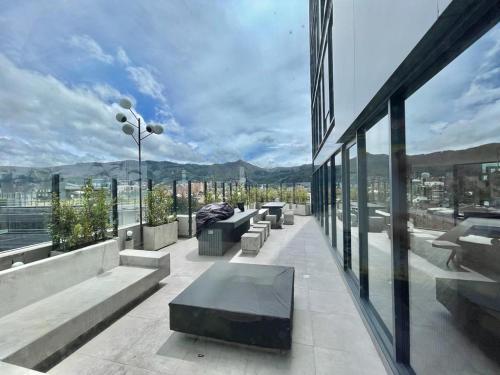 a building with benches and a view of a city at ICON 100 Luxury Apartasuites in Bogotá