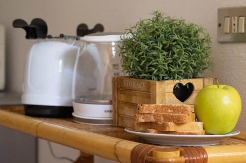 a table with a plate of bread and an apple on it at Vicoletto by PortofinoHomes in Portofino