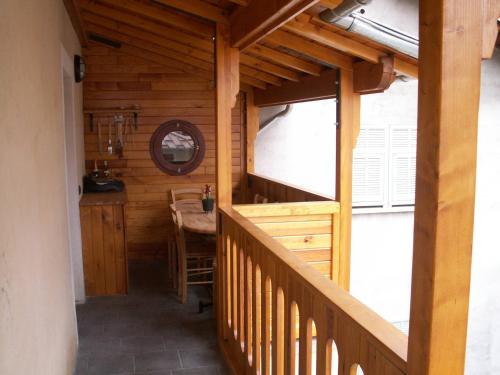 a wooden house with a staircase with a table in it at Galetas 50 in Saint-Étienne-de-Tinée