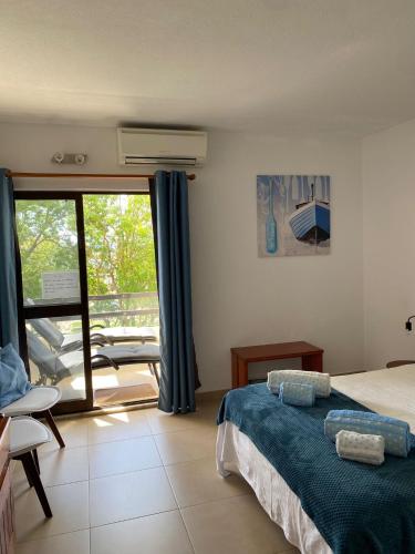 a bedroom with a bed and a view of a balcony at Perfect Summer in Cabanas de Tavira