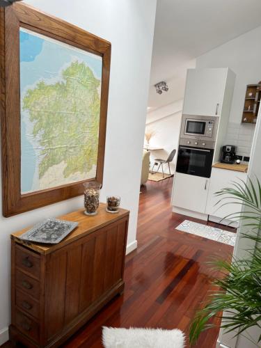 a living room with a large painting on the wall at apartamento centro in Ferrol