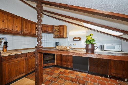 a kitchen with wooden cabinets and a counter top at Chalet Dr. Datz in Reit im Winkl