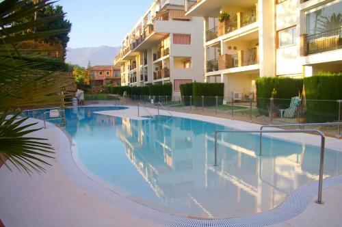 a large swimming pool in front of a building at Dream Apartment in Mijas Golf Limonar in Mijas Costa