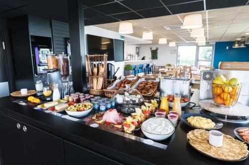 a buffet line with many different types of food at Campanile Lyon Bron Eurexpo in Bron