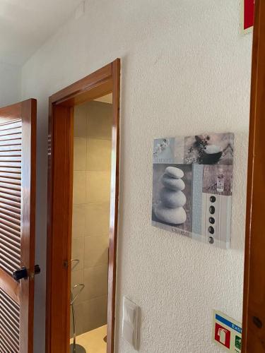 a bathroom with a mirror and some towels on the wall at Perfect Summer in Cabanas de Tavira