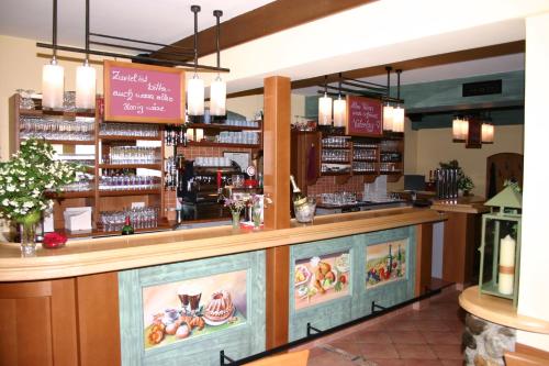a bar in a restaurant with a counter at Alpengasthof Moser in Karchau