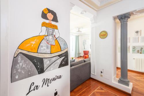 a living room with a painting of a woman on the wall at vip LETRAS, by MONARO in Madrid