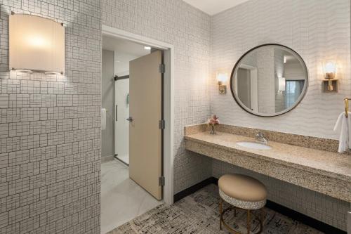 a bathroom with a sink and a mirror at Courtyard Mankato Hotel & Event Center in Mankato