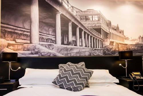 a bedroom with a painting on the wall above a bed at The Mayfield Seamer in Scarborough