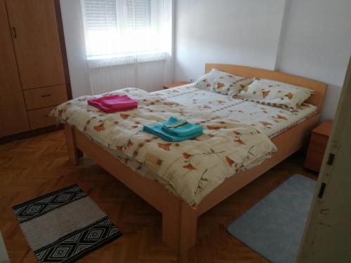 a bedroom with a bed with two bags on it at STE-FI APARTMANS in Gostivar