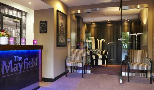 a hair salon with three chairs and a mirror at The Mayfield Seamer in Scarborough