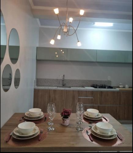 a dining room table with plates and glasses on it at LOFT DONA MARIA in Bento Gonçalves