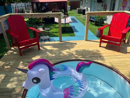 a plastic toy elephant in a pool next to two chairs at Art Graffiti in Miami