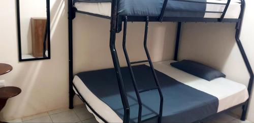 a bunk bed with a ladder in a room at Riveri Salinas V53 in Salinas