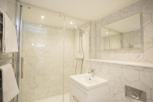 a bathroom with a toilet and a sink and a shower at Garden View in Worthing