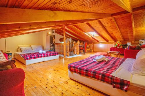 a large room with two beds and a couch at Villa George in Nea Peramos
